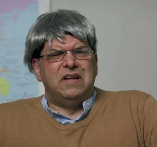 Student (gray wig and brown jumper)