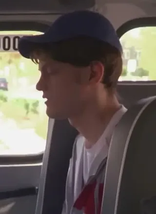 Back-seat passenger in a cap